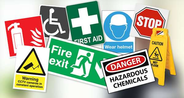 A collage of various safety and warning signs, including fire exit, first aid, and hazardous chemical warnings.